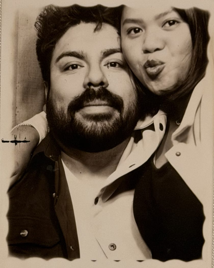 Sepia photobooth portrait of Ann and Chris cheek to cheek, mid-kiss-face
