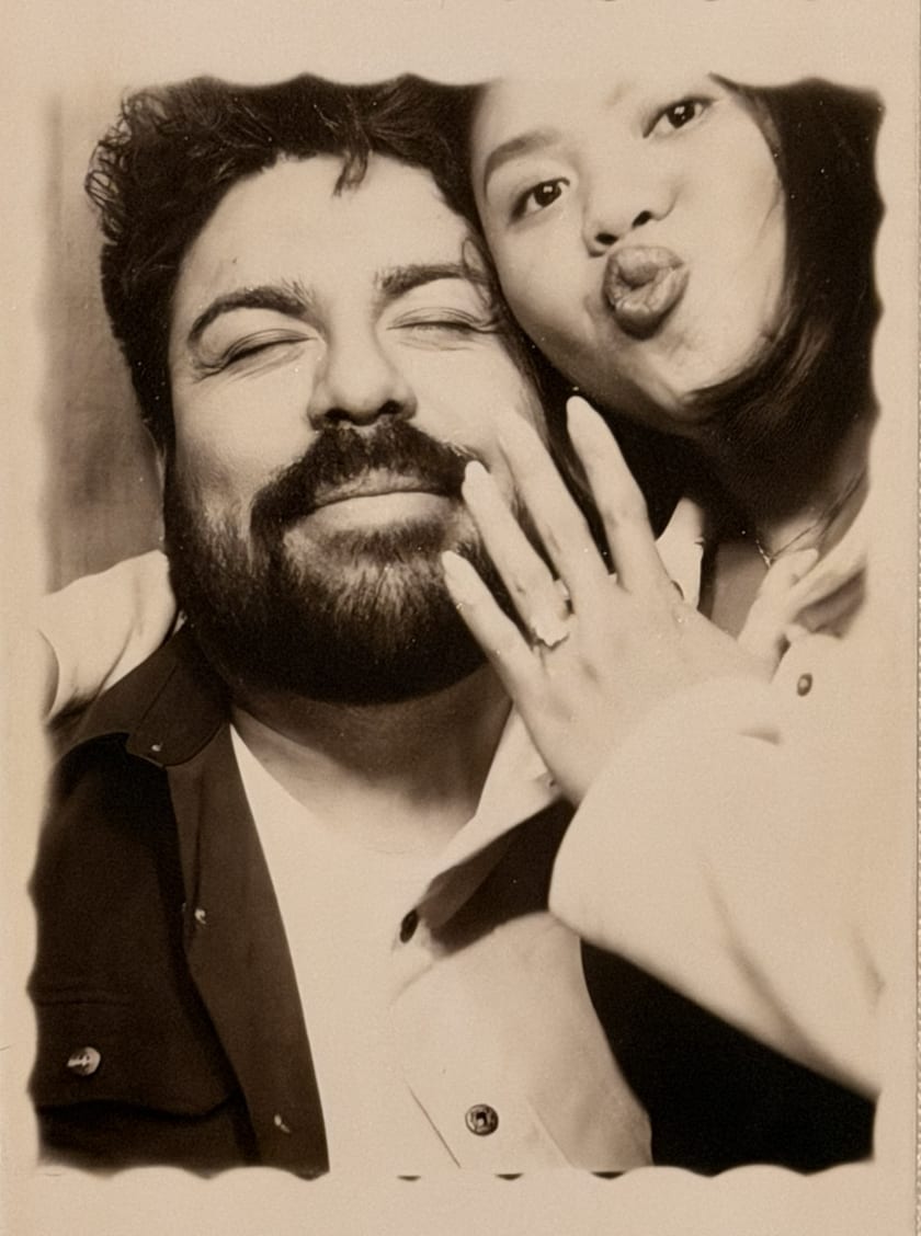 Sepia photobooth portrait of Ann and Chris laughing together