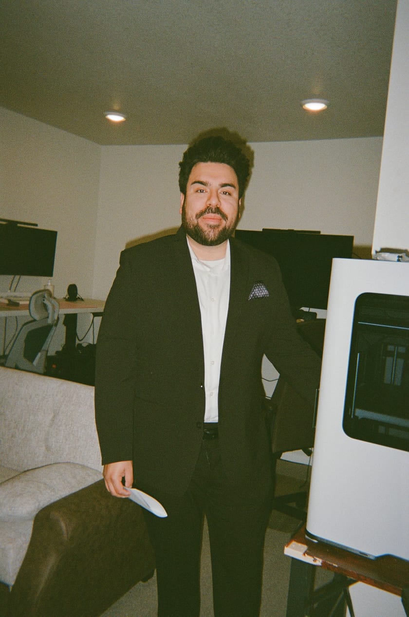 Film photo: Chris suited up at home, one of the dogs at his side