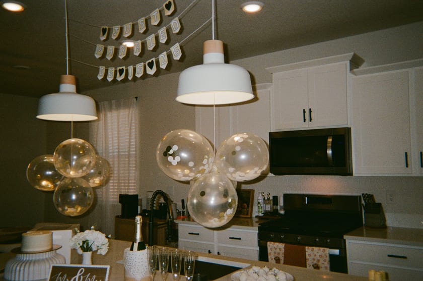 Film photo: the cake table set beneath the balloons