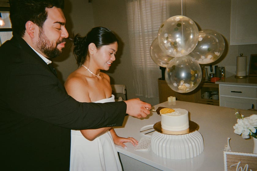 Film photo: hands stacked on the knife for the first slice