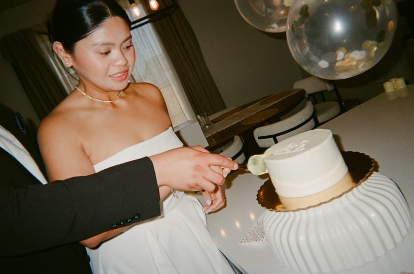 Film photo: Ann plates the first piece of wedding cake