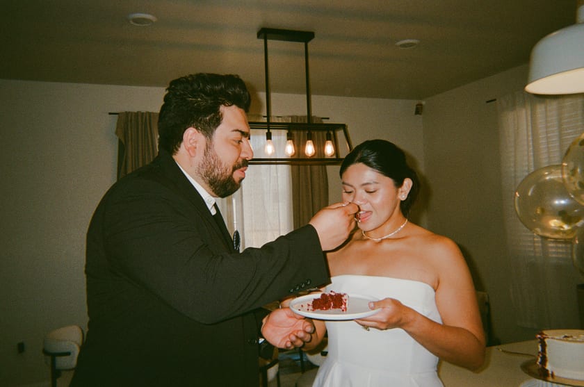 Film photo: offering the first bite of cake