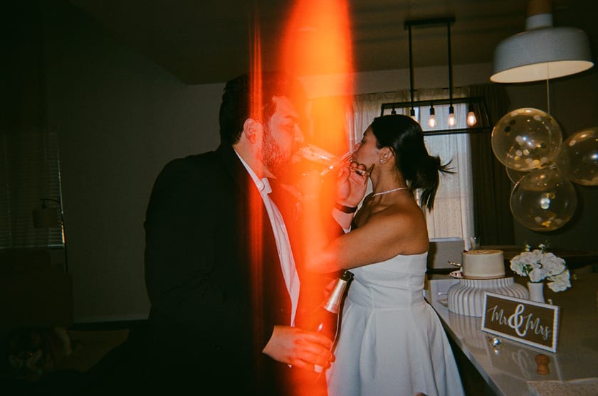 Film photo: a kiss washed in a red film light leak