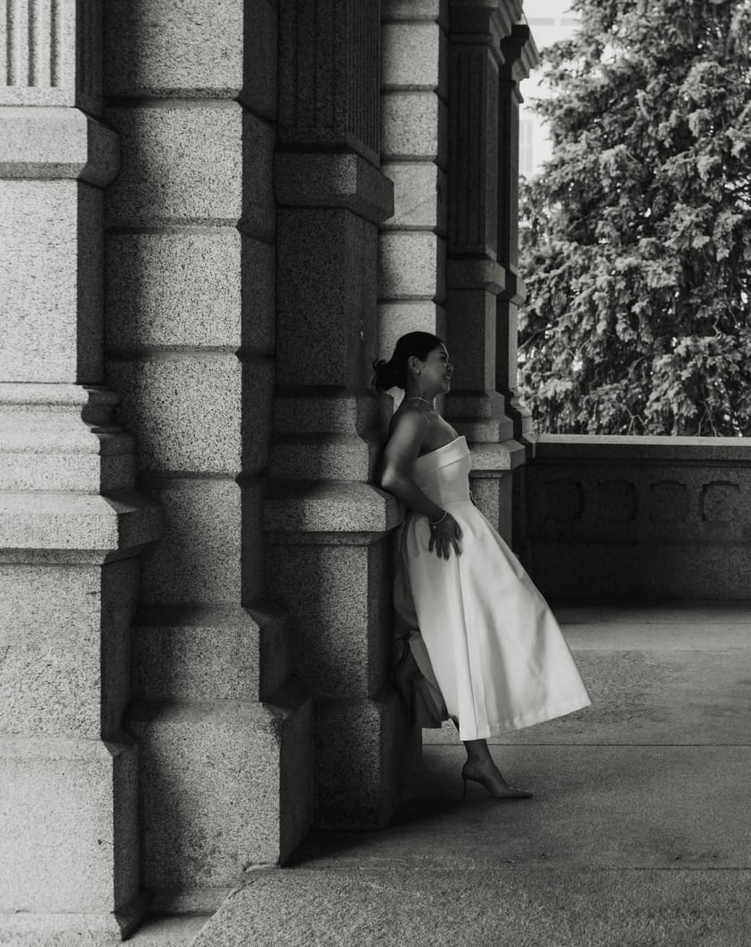 Black-and-white: Ann in the colonnade, caught in a shaft of soft light