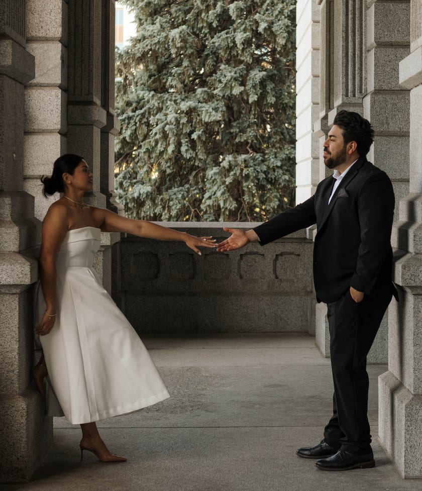 Reaching for each other across the Capitol colonnade, a blue spruce framed in the arch