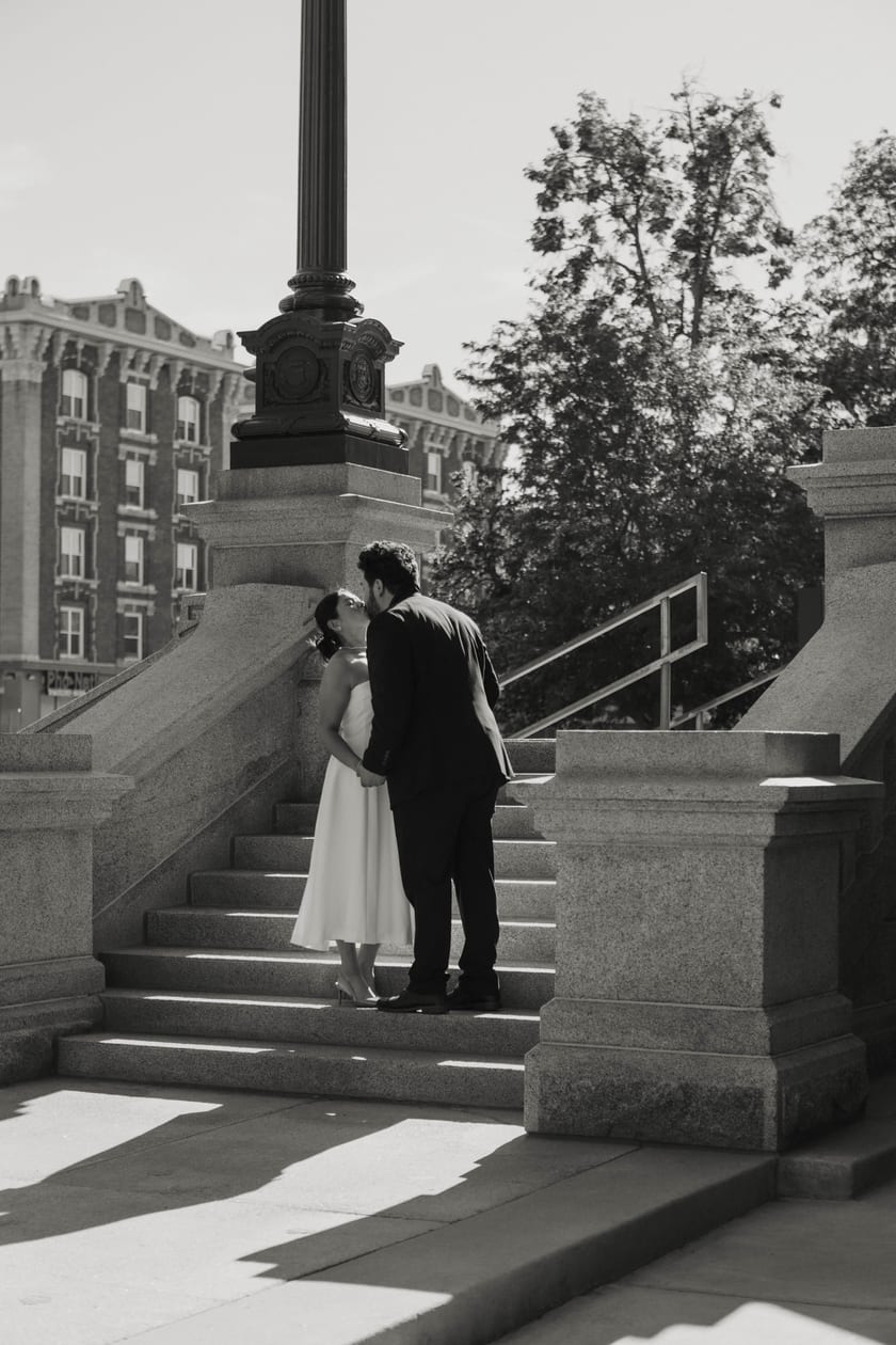 Black-and-white: an embrace on the sunlit steps