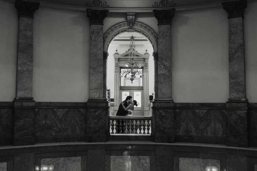 Black-and-white: framed by an interior arch beneath the chandelier
