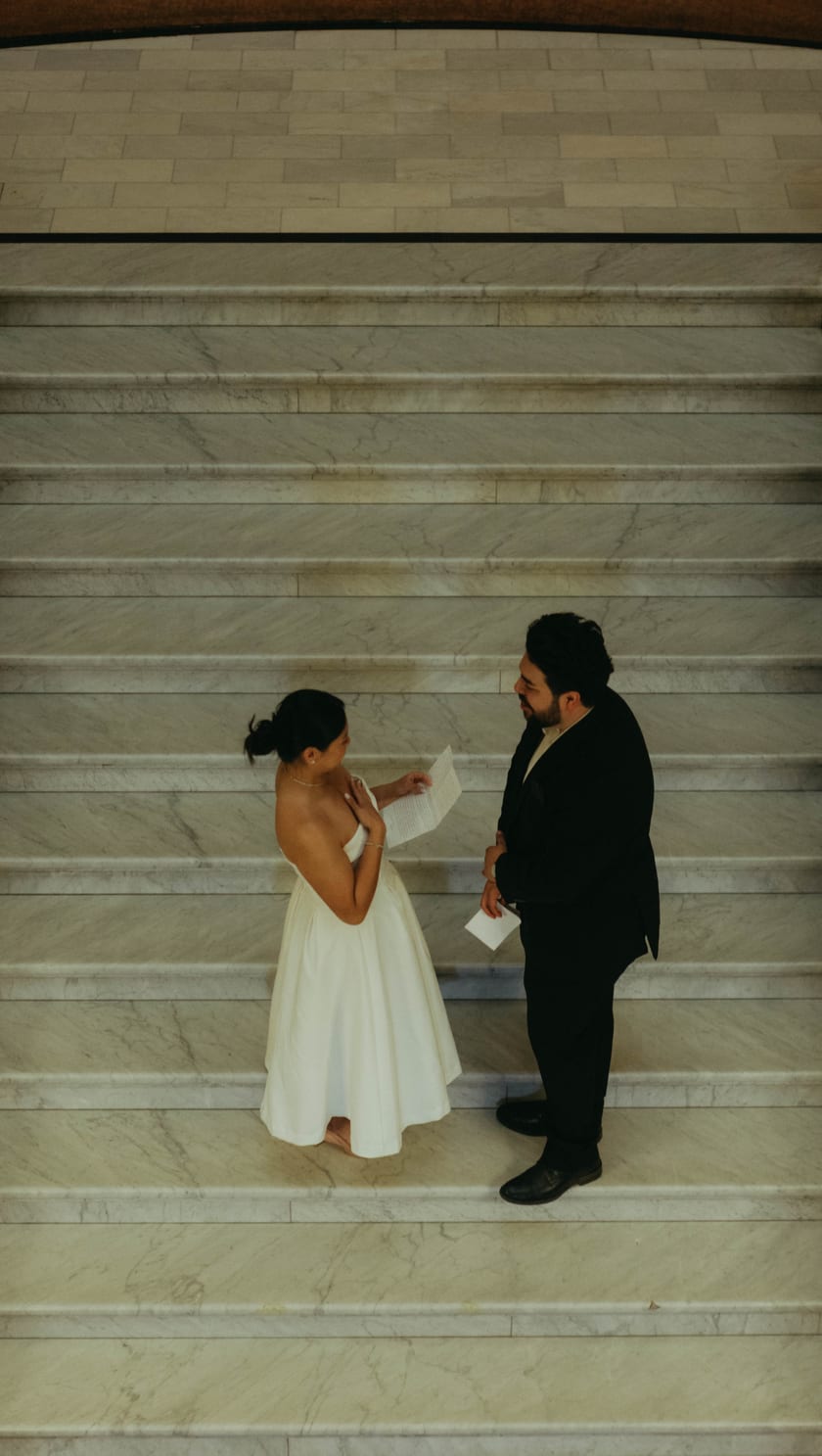 Reading handwritten vows to each other on the Capitol's marble staircase
