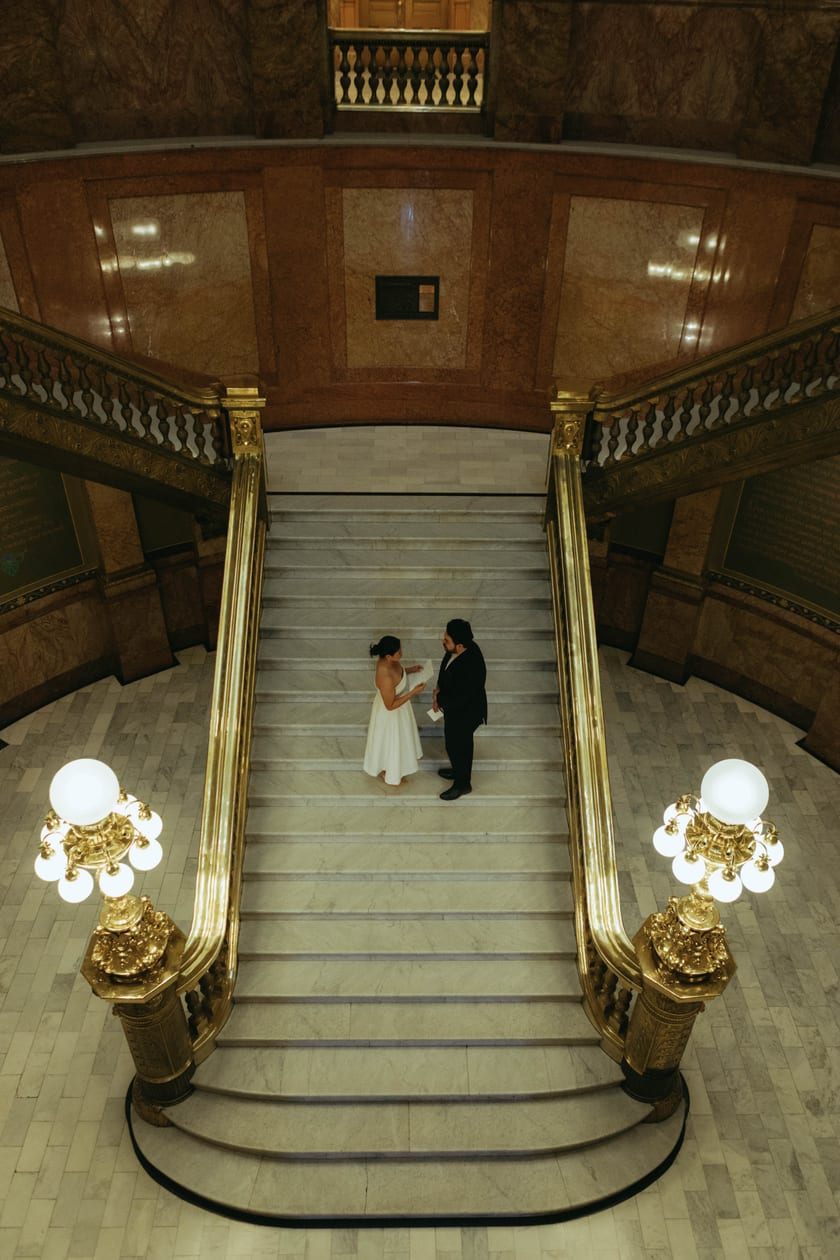 The grand staircase holds just the two of them and their vows
