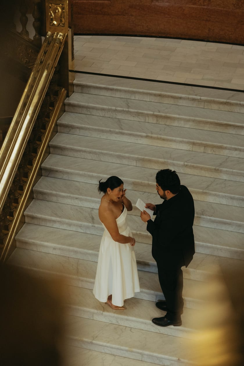A quiet word between vows on the marble steps