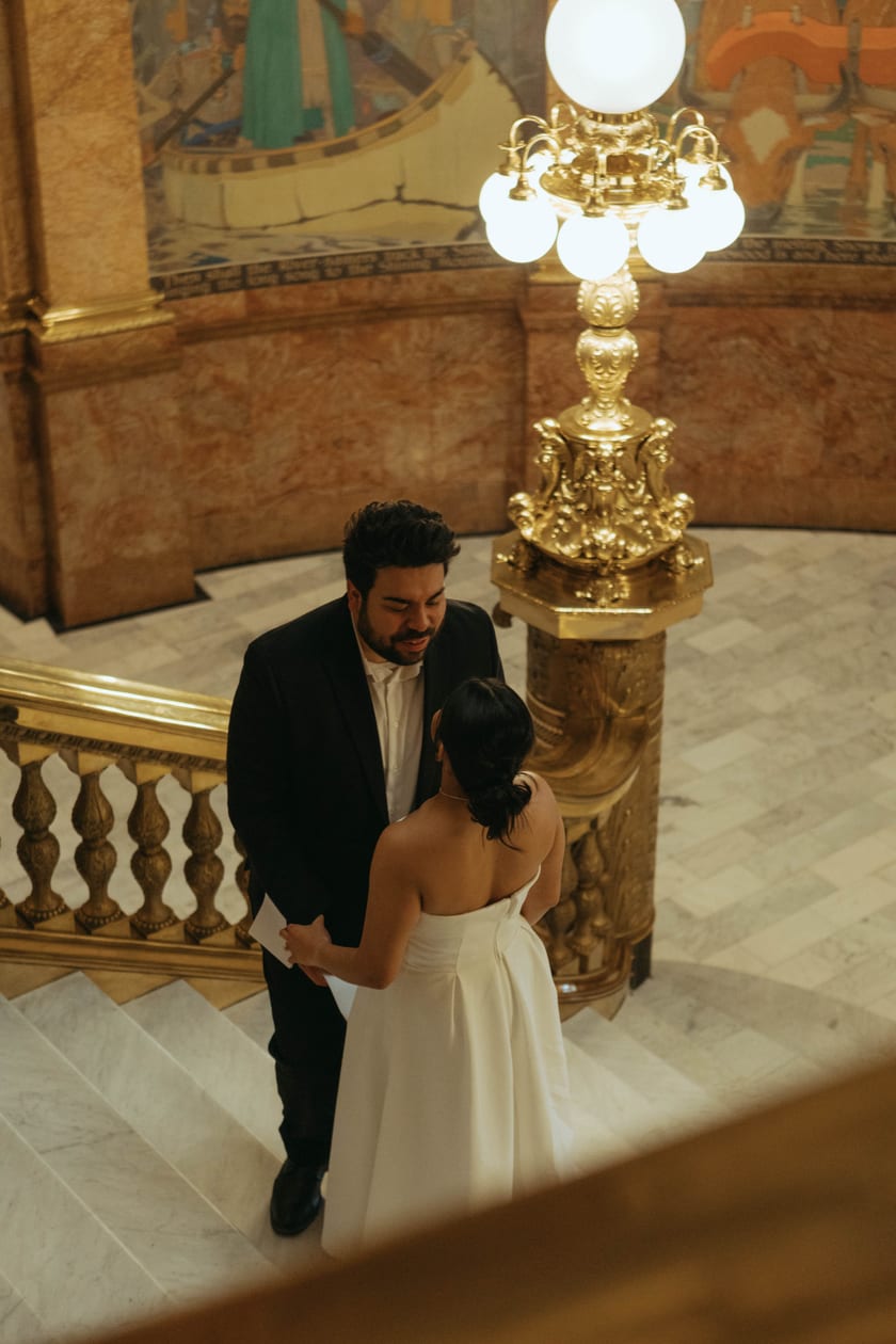 Dancing beside the brass lamp at the foot of the stairs