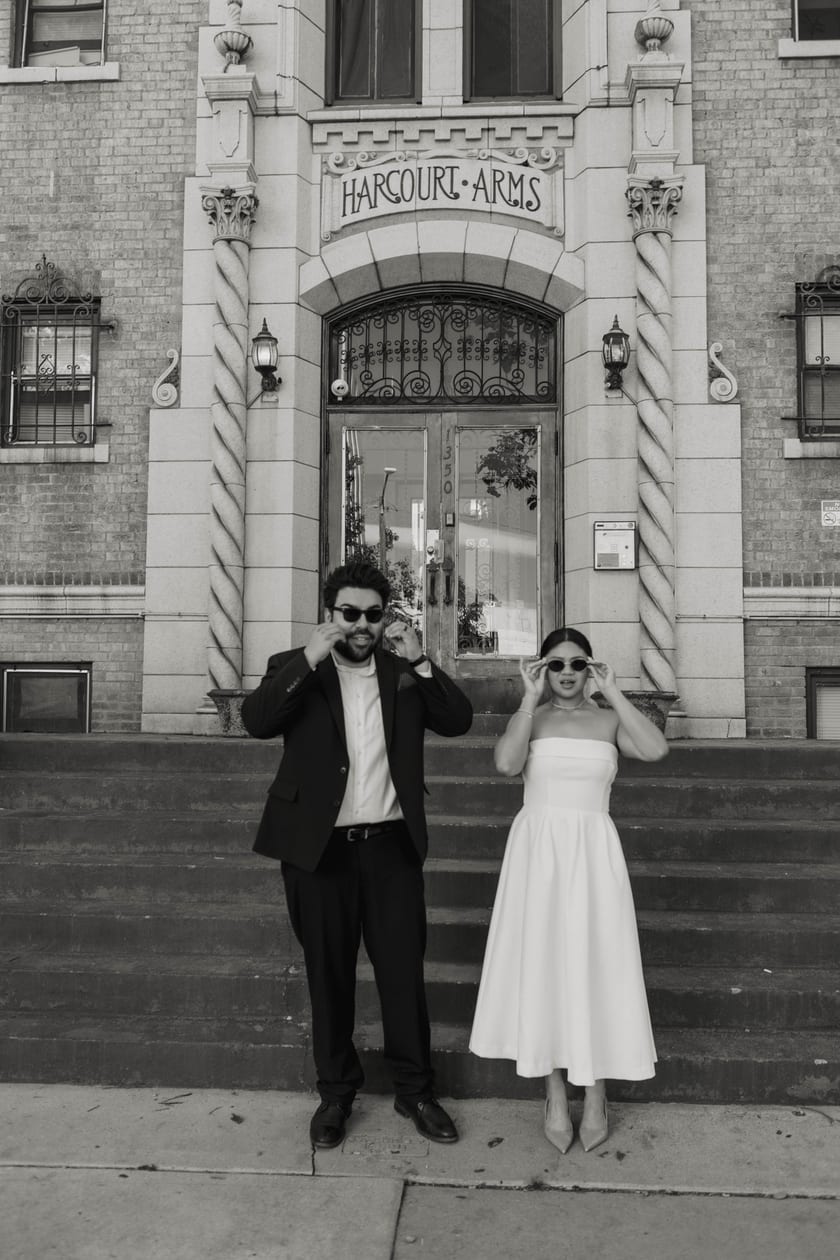 Black-and-white: sunglasses on, celebrating on the front steps